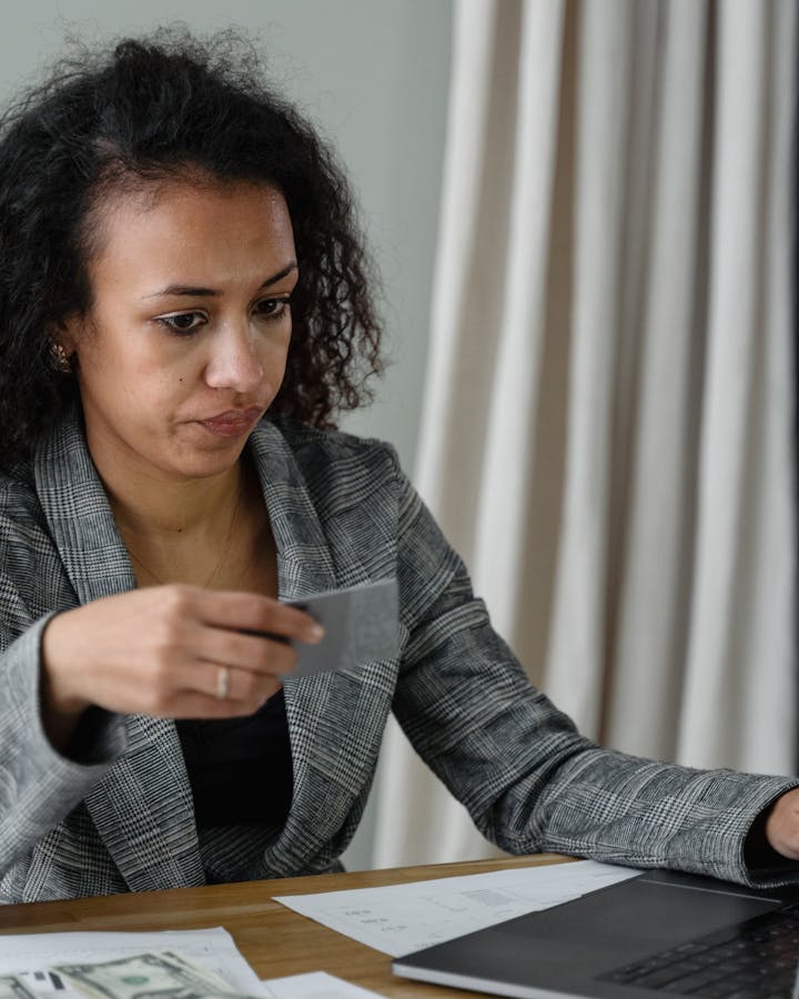 Person reviewing financial options with laptop and credit card